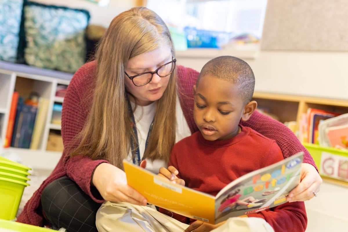 Teacher reads with student